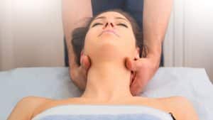 therapist-massaging-the-neck-of-woman