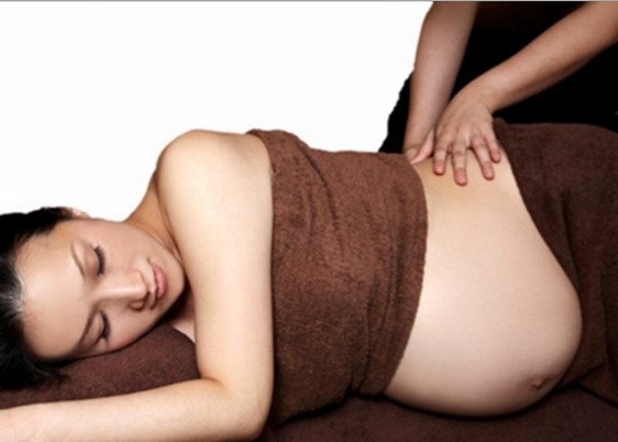 mommy to be massage - pregnant woman receiving massage